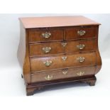 A part 19th century mahogany continental bombe chest with two short over three long draws with a sl