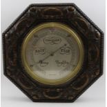 A mid 20th carved oak cased wall barometer
