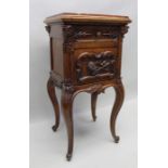 A late 19th century French caved oak bedside pot cupboard