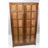 A first quarter 20th Century English arts and crafts chestnut two door