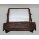 A 19th century mahogany dressing table mirror with adjustable plain plate, the bow front box base fi