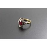 An 18ct gold band, set diamonds in an Art Deco mount, presenting a central facet cut ruby, ring size