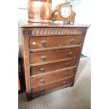 A reproduction oak finished chest of five drawers