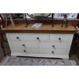 A part painted oak topped low seven drawer chest