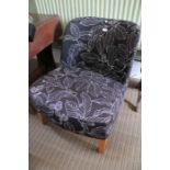 An Ikea easy chair with black & white leaf pattern