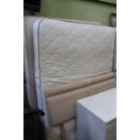A double divan bed base with mattress and headboard
