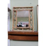 A bamboo framed wall mirror