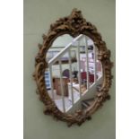 A late 20th century fancy gilt framed plain plate wall mirror