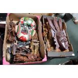 Two boxes of wooden carvings etc.