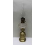 A Victorian oil lamp 42cm high, with glass funnel, 66cm, brass base with frieze of raised classical
