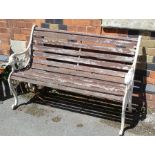 A white cast iron garden bench