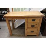 A small oak desk with single column of three drawers