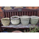 Four various cast circular garden planters