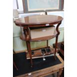 An early 20th century mahogany oval topped table, with similar undertier