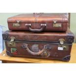 A well travelled leather suit case together with a combination brief case (unknown code)