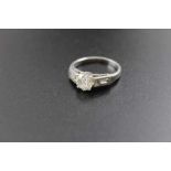 A platinum ring, set central brilliant cut diamond