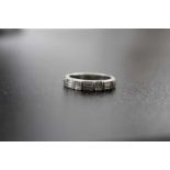 A white metal ring set diamond baguettes, weight: 7.5g, ring size O 1/2