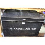 A black deed box, with side handles, printed "The Charles Lane Trust"