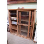 A late 19th century pine bookcase with sliding glazed doors