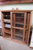 A late 19th century pine bookcase with sliding glazed doors