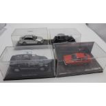 A collection of four model cars various