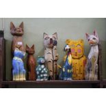 A selection of painted wooden cats