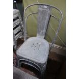 A pair of industrial galvanised metal chairs bearing the brand TOLIX