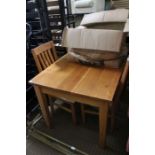 A modern oak rectangular topped table, together with four slat back single chairs, with ivory seat p