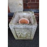 A cast concrete square formed garden planter, and two terracotta pots