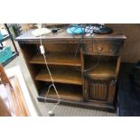An "old charm" low bookcase unit, with single drawer and cupboard