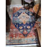 A woven woollen, aged geometric patterned floor carpet