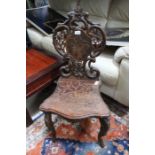 An early 20th century alpine single chair with edelweiss back