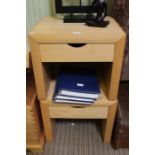 A pair of modern blonde wood single drawer bedside tables