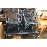 A pair of black finished bamboo tub chairs, together with a large matching coffee table