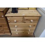 A small sized modern pine five drawer chest