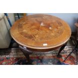 A fancy inlaid topped mixed wood round table on four legs