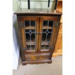 A Old Charm oak finished hi-fi cabinet with twin leaded doors over single drawer