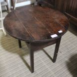 A small circular oak table with lift up central section