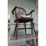 A traditional wheel back country kitchen armchair