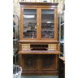 A 19th century oak secretaire bookcase, well fitted interior, and well carved frontage