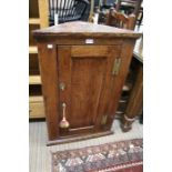 A small Georgian oak hanging corner cupboard