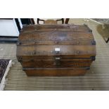 A decoratively painted dome top tin trunk containing a deed box, a letter rack, and two unframed pic