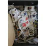 A box containing many hundreds of cigarette cards, much to sort