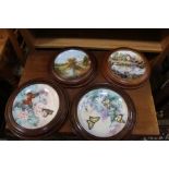 Four decorative wall plates, two limited edition with butterflies, and two others