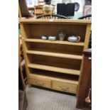 A solid oak bookcase with drawers to base