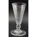 An 18th century wrythen ale glass, with knop and circular platform foot, with unground pontil, c.177