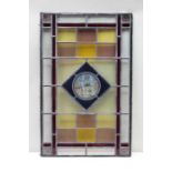 A first quarter 20th century multi-coloured leaded glass panel, with elephant and castle central mot