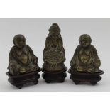 Three 19th century cast brass Eastern Deities / Buddhas, each raised upon wooden plinth bases, the t