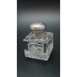 An early 20th century silver mounted facet glass desk inkwell, with hobnail base, the hinged silver