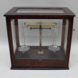 Griffin & George, A brass laboratory balance scale, in glazed mahogany display cabinet